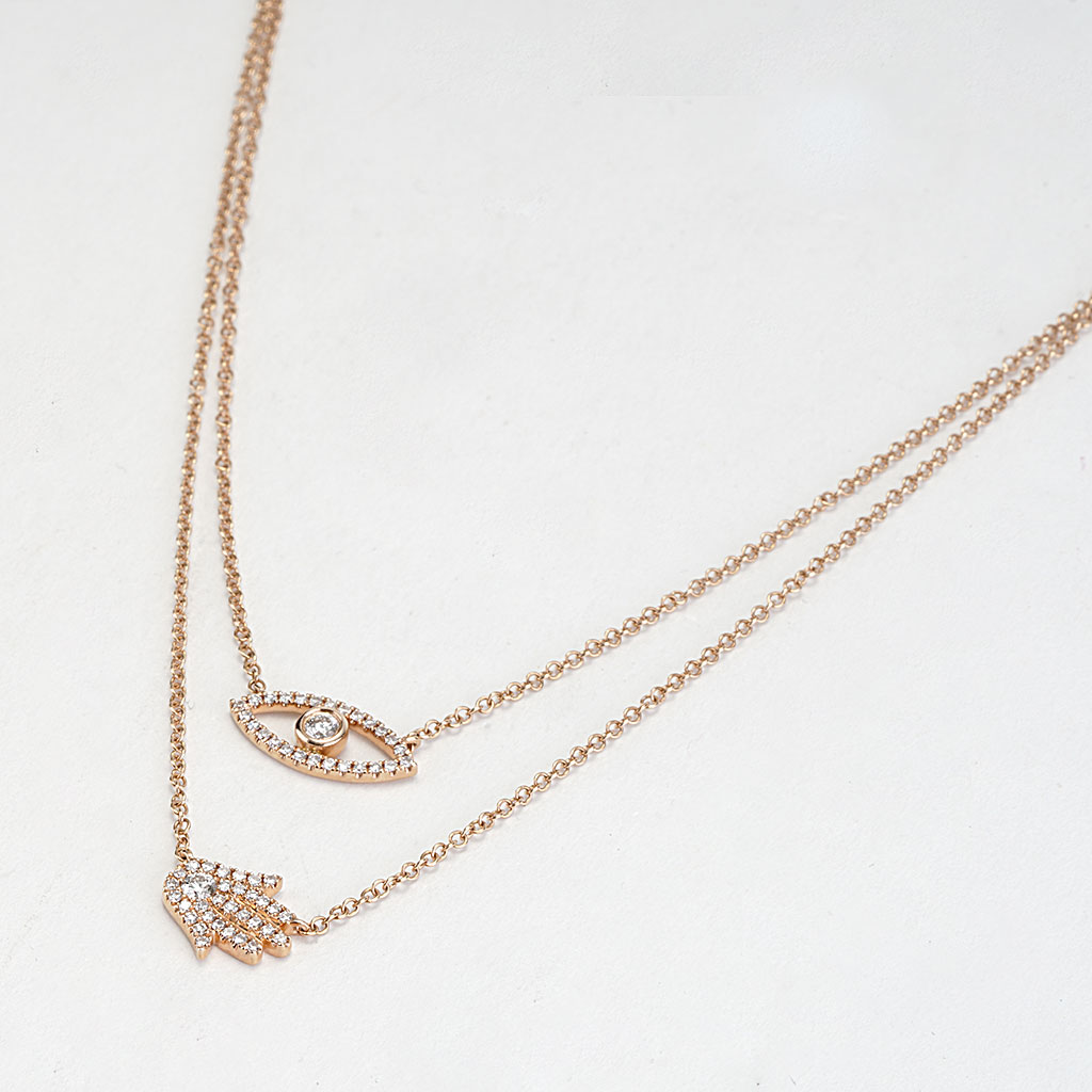 Two layered rose gold necklace with evil eye and hand of hamsa in cz 