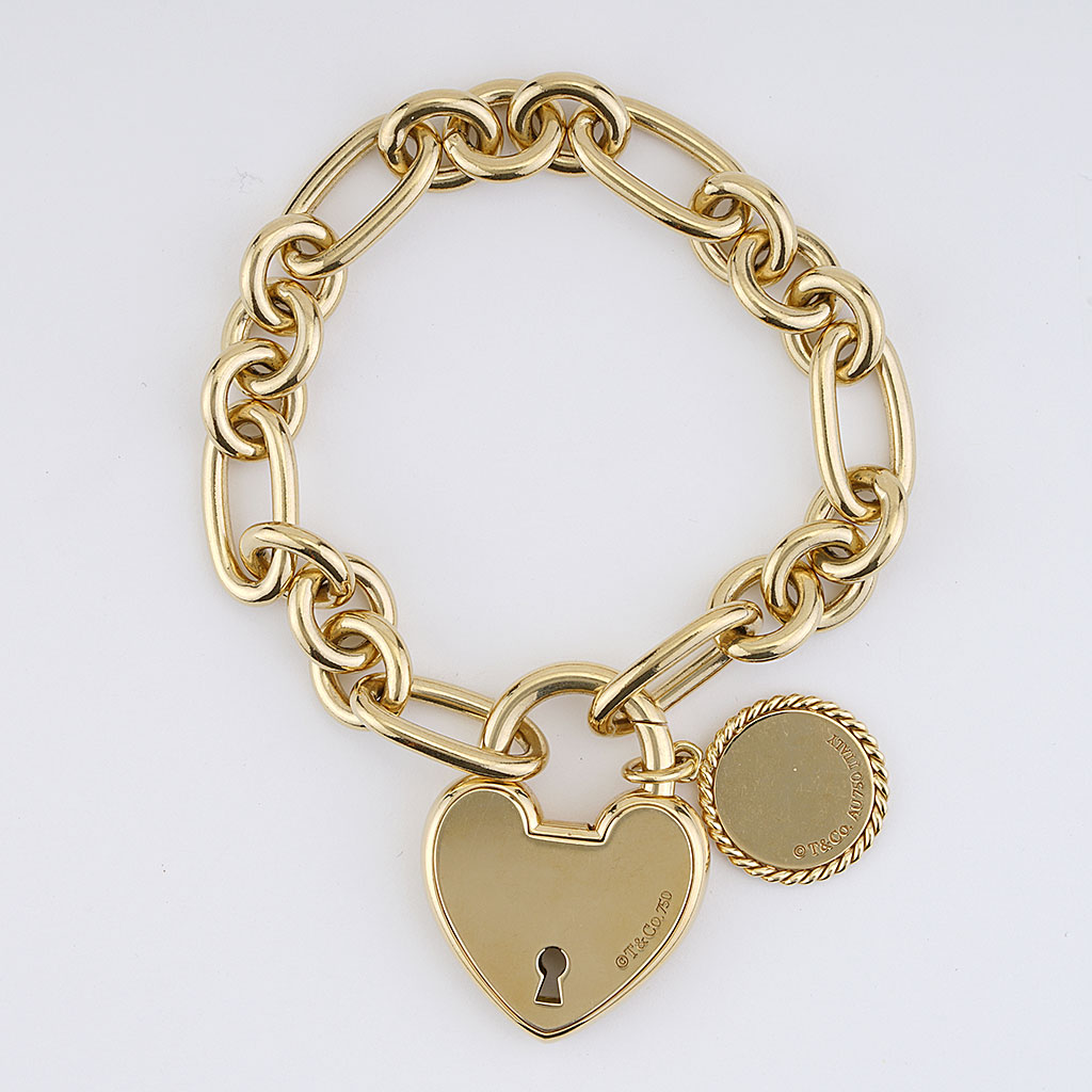 Lot - Tiffany & Co. 18K white gold charm bracelet with sapphire mounted  horseshoe charm. Marked on link.